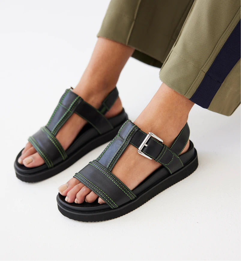 Elegant and sophisticated women's shoes for any formal eventVisby T-Bar Sandal | Black leather with Green Topstitch